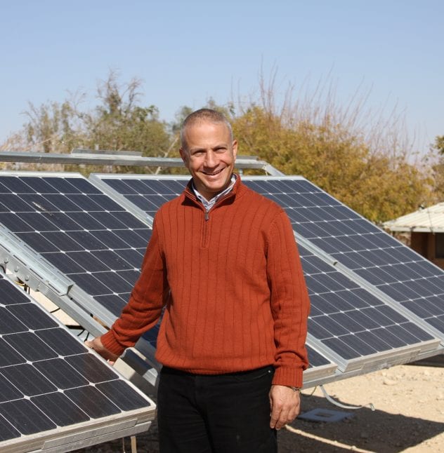 Dr. Tareq Abu Hamed in front of solar panels