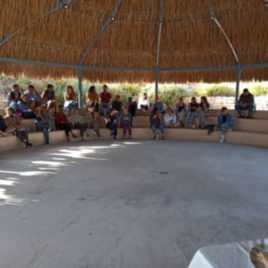blurred photo of students sitting in a circle