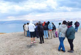 group of students under cloudy blue sky